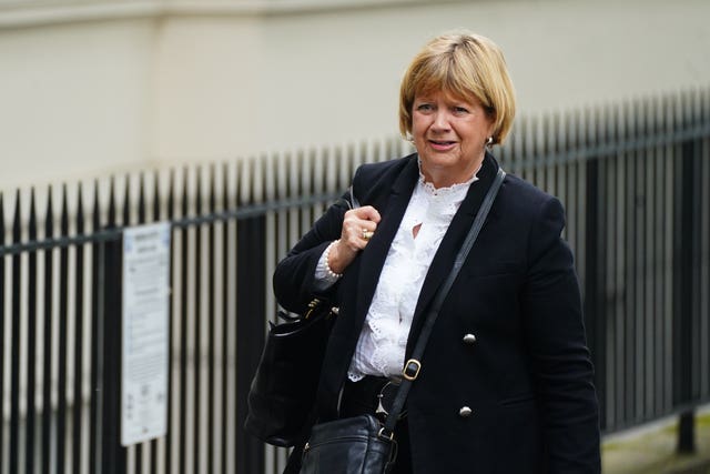 Baroness Heather Hallett walking past iron railings