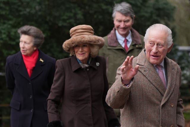 Charles, front right, waving, as Camilla, Anne and her husband follow behind him
