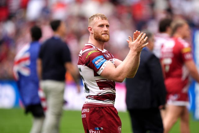 Wigan forward Luke Thompson applauds the fans