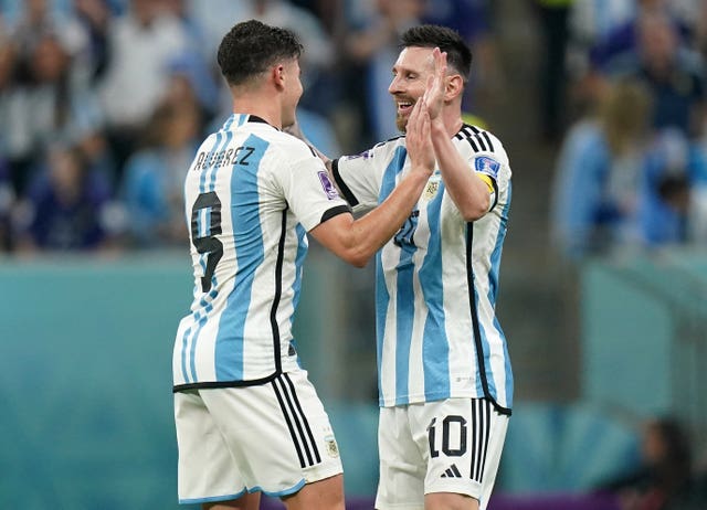 Lionel Messi congratulates Julian Alvarez, left, after Argentina''s third goal