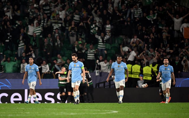 Bernardo Silva, centre left, and team-mates, from left, Jahmai Simpson-Pusey, Manuel Akanji and Mateo Kovacic react to Sporting Lisbon''s second goal