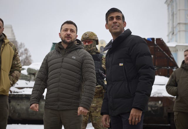 Handout photo issued by the Ukrainian Presidential Press Office of Prime Minister Rishi Sunak, with Ukraine President Volodymyr Zelensky as they look at destroyed Russian military vehicles in Kyiv, Ukraine