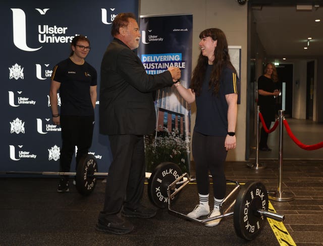 Arnold Schwarzenegger talks to pharmacy student Minnie Dihmis as he arrives at Ulster University in Belfast ahead of being presented with an honorary doctorate