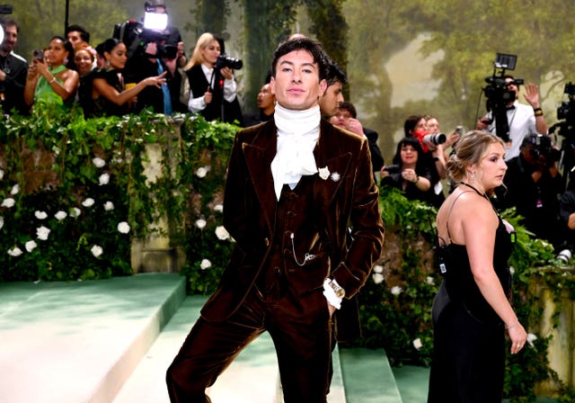 Barry Keoghan in a velvety burgundy jacket and ruff collar at the Met Gala 