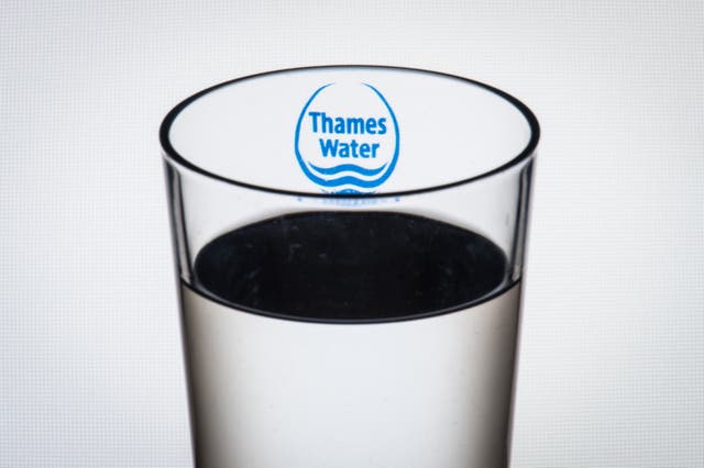The logo of water company Thames Water seen through a glass of water