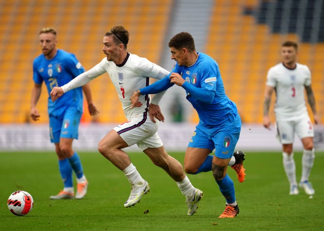 Jack Grealish (left) and Italy’s Giovanni Di Lorenzo battle for the ball