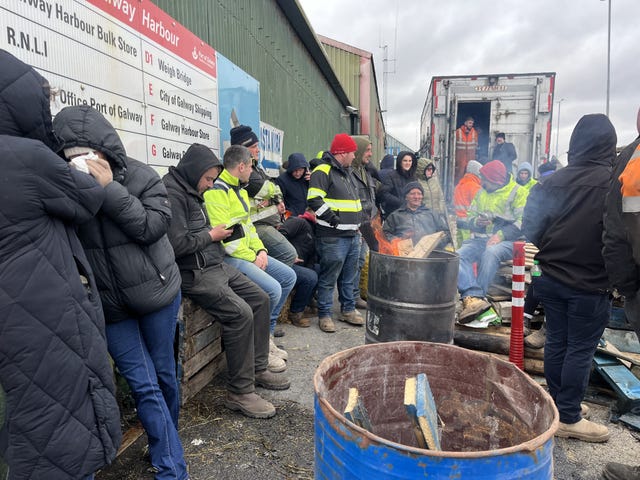 Protesters gathered round a fire in a barrel