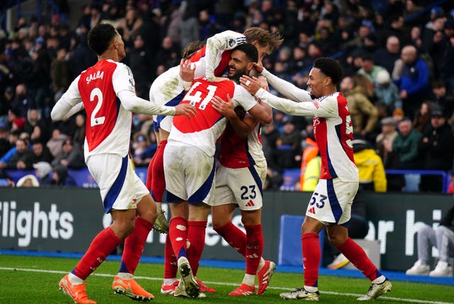 A number of Arsenal players jump on Mikel Merino in celebration after he scored his second goal. 