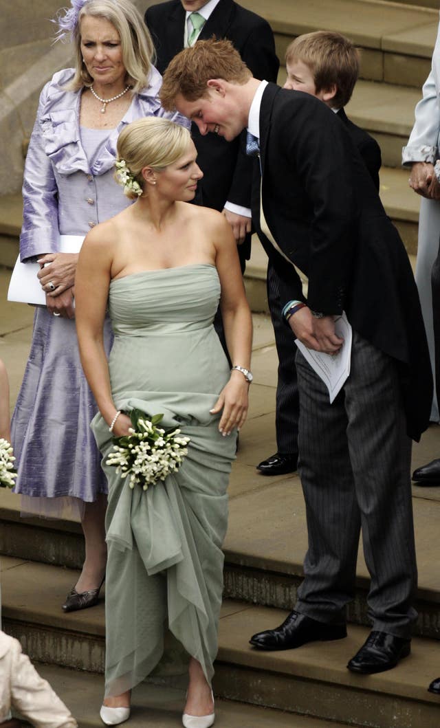Prince Harry talks to his cousin Zara Phillips after the marriage of Peter and Autumn Phillips (PA)