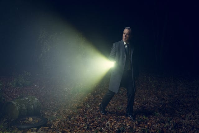 James Nesbitt holds a torch as he walks across a field in Netflix’s adaptation of Harlan Coben’s 2019 thriller Run Away 