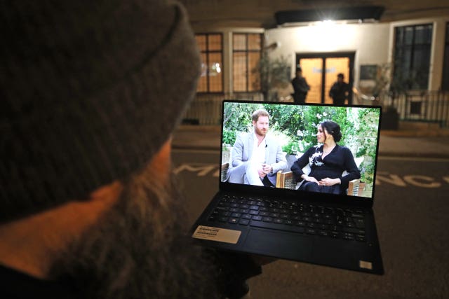 A man watches the Duke and Duchess of Sussex interview with Oprah Winfrey on ITV on March 8 2021 (Yui Mok/PA)