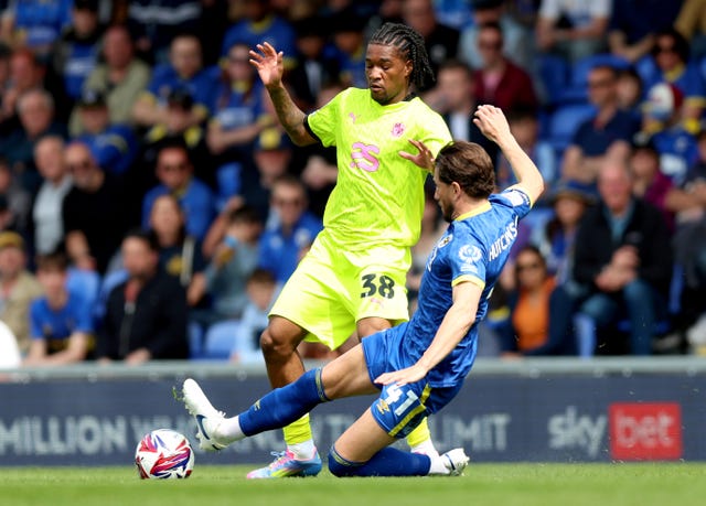 Sam Hutchinson, right, makes a tackle