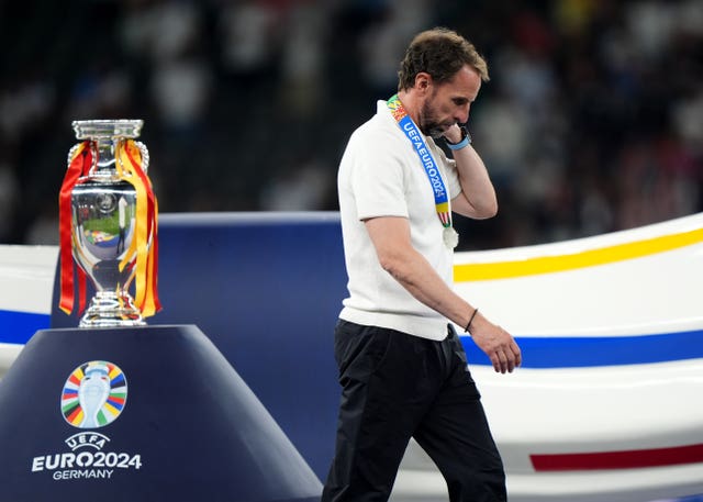 England manager Gareth Southgate walks past the Euro 2024 trophy 