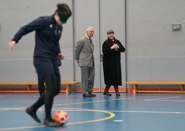 King Charles watching a demonstration of blind football during his visit to Royal National College for the Blind (RNC) in Hereford
