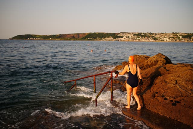 People preparing to enter the water in Penzance, Cornwall (