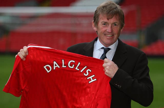 Kenny Dalglish holds up a Liverpool shirt
