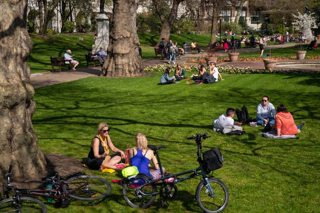 Relaxing in the sun at Victoria Embankment Gardens in Central London