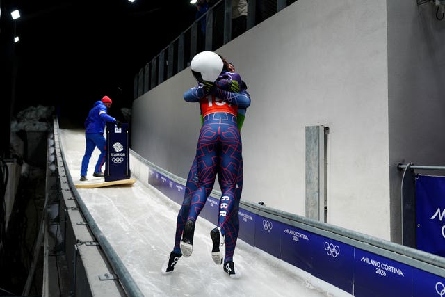 Matt Weston and Tabby Stoecker embrace after winning gold