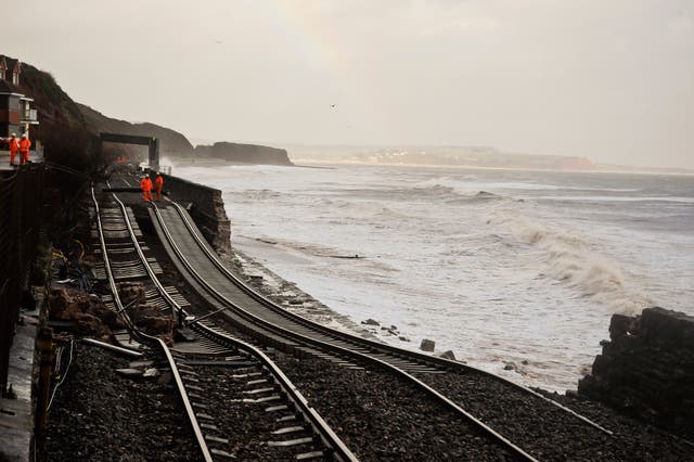 A huge length of railway track is exposed and left hanging after the sea wall collapsed in Dawlish in 2014