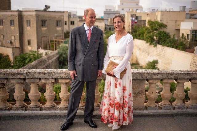 Edward and Sophie pose on the roof of Villa Guardamangia, with Malta in the backdrop