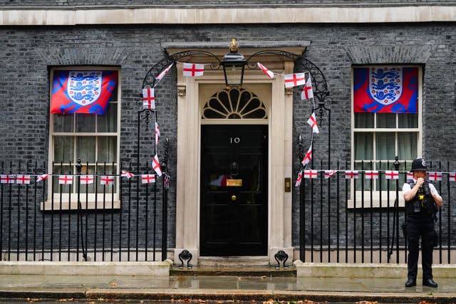 Number 10 Downing Street with union jack flag bunting and England football logos on flags