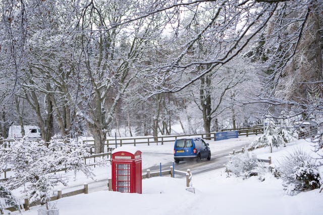 Snowy road and red phone box