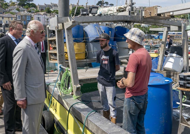 The Prince of Wales talks to local fishermen