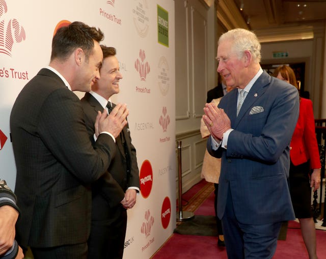 Charles uses a Namaste gesture at the Prince's Trust awards ceremony to greet television presenters Ant McPartlin (left) and Declan Donnelly during the royal's last public appearance before he contracted coronavirus. Yui Mok/PA Wire