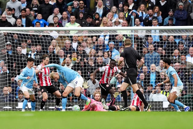 Erling Haaland, centre left, scores Manchester City’s second goal against Brentford with a backheel