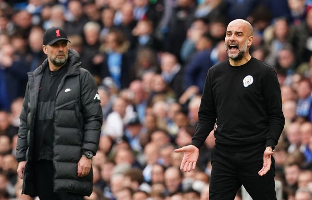 Manchester City manager Pep Guardiola (right) and Liverpool boss Jurgen Klopp on the touchline