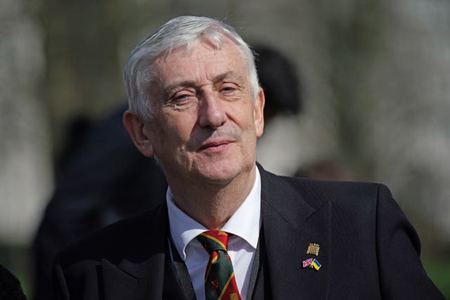 Sir Lindsay Hoyle wearing a black suit, white shirt and green and red tie