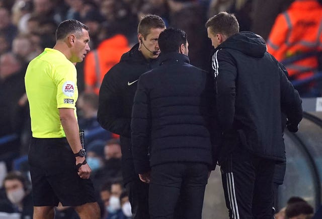 Mikel Arteta speaks with referee Andre Marriner (left) and fourth official John Brooks after alleged racist abuse was aimed at the Arsenal bench