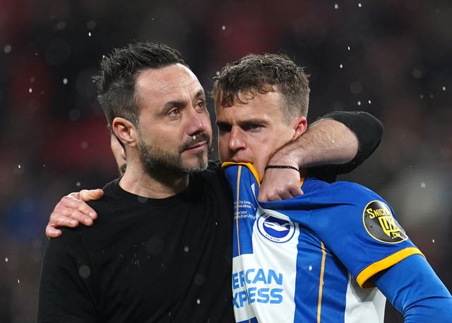 Roberto De Zerbi, left, comforts Solly March after his penalty miss