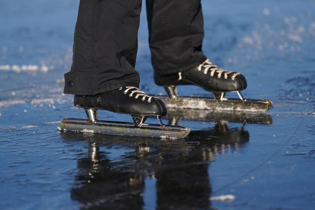 Paul Jansen skates on the frozen flooded field 