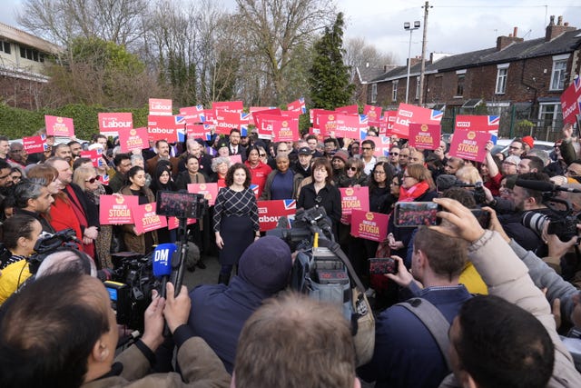 Lucy Powell (centre) and Anna Turley (right) flank Angeliki Stogia (centre left) standing in front of Labour supporters holding red placards