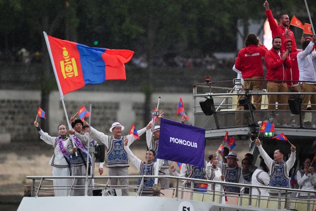 The Mongolia team travel down the Seine during the opening ceremony of the 2024 Olympic Games