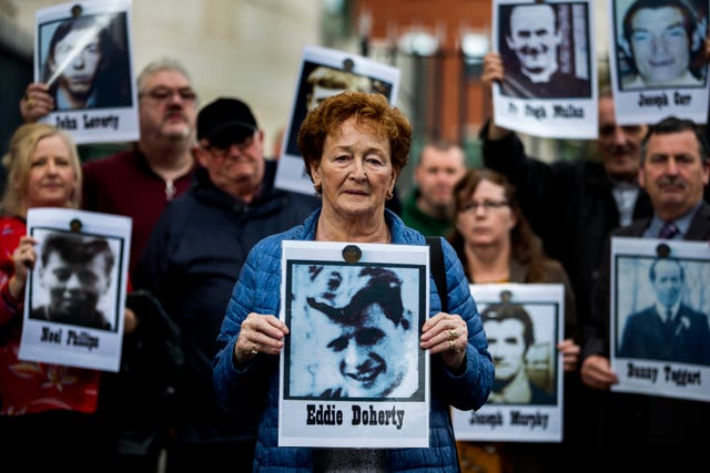 Kathleen McCarry holds an image of her late brother Eddie Doherty (Liam McBurney/PA)