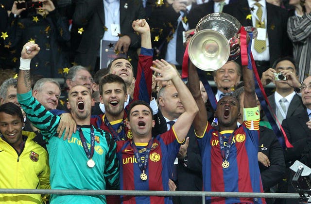 Barcelona captain Eric Abidal (right) lifts the Champions League trophy with team mates Victor Valdes (left) and Xavi