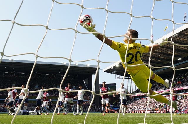 Fraser Forster tries to use his left hand to stop the ball from going in the net