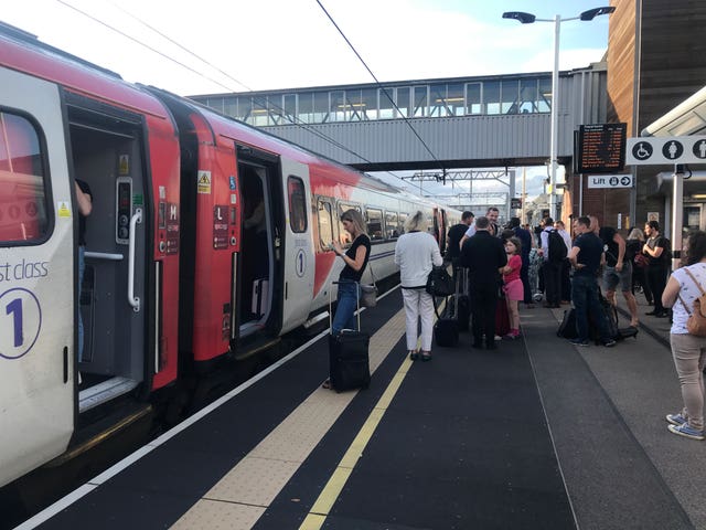 Passengers wait for news at Peterborough station during travel disruption on the East Coast mainline after a large power cut 