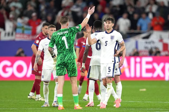 Jordan Pickford and John Stones celebrate together at full-time after England beat Serbia