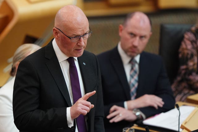 John Swinney pointing while speaking in Holyrood