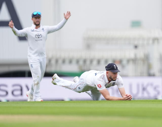 Gus Atkinson dives forward to take a catch to remove Akash Deep