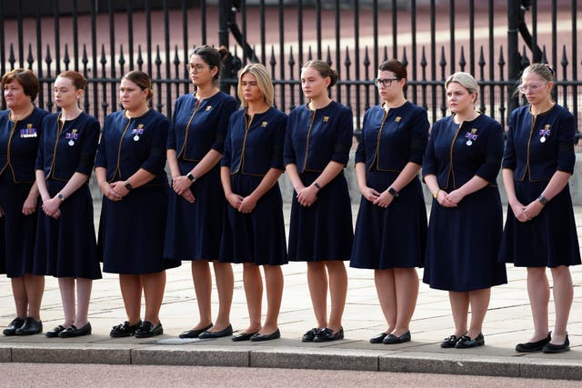 Buckingham Palace household staff pay their respects outside Buckingham Palace during the coffin procession from Westminster Abbey to Wellington Arch, London.  (Carl Court/PA)