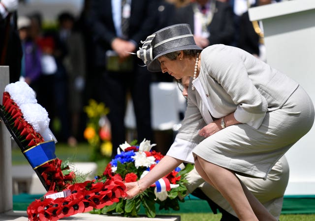 Theresa May lays wreath