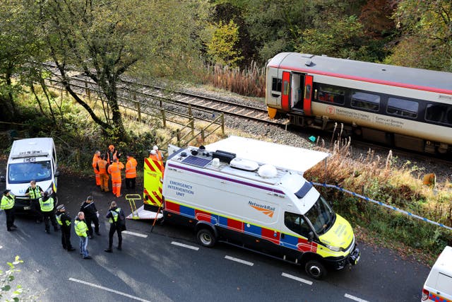 Emergency workers and vehicles at the scene of a train crash