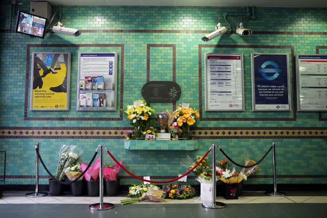 Flowers left by the July 7 memorial plaque at Aldgate Station, London 