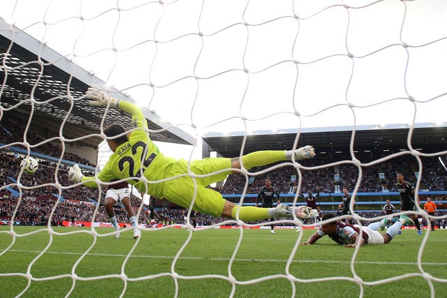 David Raya dives to his left to keep out an Ollie Watkins header