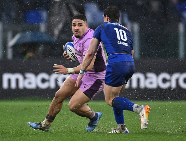 Scotland’s Sione Tuipulotu (left) and Italy's Paolo Garbisi compete for the ball