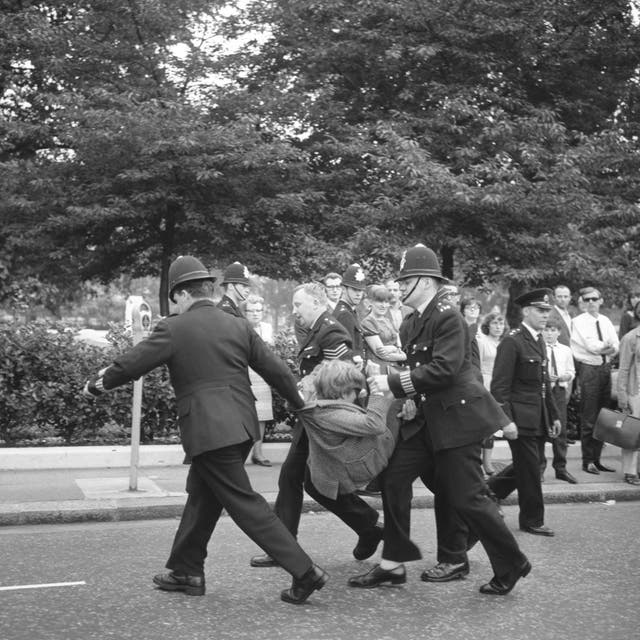 Police carry away a Vietnam War protester in Grosvenor Square (PA)
